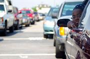 Gloria Atkins looks toward the gas pumps as she waits in line at a Sam's Club gas station Wednesday in Morrow, Ga. Atkins drove through the line in reverse so the gas cap would be on the right side of the pump. The lines were 15 cars deep per pump because of the comparatively cheaper prices.