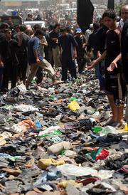 Shoes and other belongings of the victims are seen on a bridge over the Tigris river in Baghdad, Iraq. A railing collapsed Wednesday on the bridge packed with Shiite worshippers marching in a religious procession, sending crowds tumbling into the Tigris River. At least 840 people died.