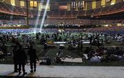 Members of the National Guard stand in the end zone and watch over people who took shelter at the Louisiana Superdome in New Orleans in the aftermath of Hurricane Katrina. With the situation in the smelly and sweltering Superdome becoming ever more desperate, authorities have found a new home for the building's nearly 25,000 hurricane refugees: the Astrodome in Houston.