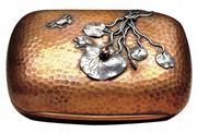 This mixed-metal soap dish by Gorham has brass inside, copper outside and applied lilies, crabs and frogs of copper and silver. The 4-inch-wide piece sold for $1,035 at a James Julia auction in Fairfield, Maine.