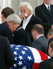 Supreme Court Justice Sandra Day O'Connor, center, watches as the coffin of Chief Justice William Rehnquist is carried into the Great Hall of the Supreme Court in Washington. O'Connor had known Rehnquist since they were classmates at Stanford University's law school more than half a century ago.
