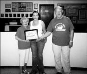 Nichole Kennedy, center, receives the third annual James Hill Memorial Scholarship in this August file photo. She is pictured with Bridgie Hill, widow of James Hill, and John Callewaert, grand knight of the Knights of Columbus Council 1372.