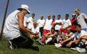 Coach Lori Navarro talks with the Liberal High School varsity soccer team during a practice in Liberal. Everyone on the team - players, coaches, trainers and managers - are Hispanic, and both English and Spanish are spoken.