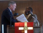 U.S Rep. Dennis Moore, left, and St. Luke's AME minister Verdell Taylor, greet each other Saturday during St. Luke's celebration of efforts to restore the church at 900 N.Y.