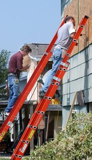 Dan McCarty, 56, of Houston, left, and Terry Mittendorf, 49, of Pasadena, Texas, board up the windows on the Crystal Beach, Texas, home of Mittendorf's girlfriend Tuesday in preparation for the possibility that Hurricane Rita will strike the Texas Gulf Coast.