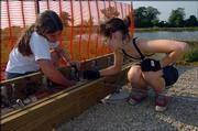 Cooper Farr, 17, and Emma Burgess-Olson, 16, work on a stage at the Lawrence Rotary Club Arboretum as part of a project to achieve the Girl Scout Gold Award, the highest award given in Girl Scouting. The girls, members of Troop 736, worked on the project Sept. 10.
