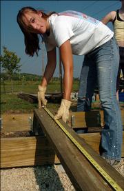 Maggie Hall, 17, helps build a stage at the Lawrence Rotary Arboretum, along the South Lawrence Trafficway Trail at 27th Street and Wakarusa Drive. Hall, a member of Girl Scout Troop 736, was building the stage Sept. 10 along with other members of her troop. They were working on the project as part of the Girl Scout Gold Award, the highest award given in Girl Scouting.