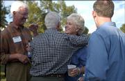 Sue Hack, center right, Lawrence city commissioner, greets Chris Forbes during Taste of Lawrence, the Lawrence Chamber of Commerce's annual fall event that honors educators. Al Hack, Sue's husband, left, and State Representative Paul Davis, D-Lawrence, right, look on. The mixer was Sept. 14 at the northeast corner of Bob Billings Parkway and Crestline Drive.