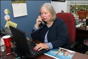 Executive Donna Cook works Friday in her Arlington, Va., office. When menopausal hot flashes caused sweat to run down Cook&squot;s face during business meetings, she joked to concerned colleagues, "I&squot;m having my personal summer."
