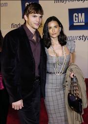 Actors Ashton Kutcher, left, and Demi Moore arrive for a fashion show in Los Angeles in this Feb. 22 file photo. Kutcher, 27, and Moore, 42, got married at a private home Saturday, Us Weekly and People reported on their Web sites.