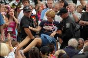 Police carry Cindy Sheehan, the California woman who has used her son's death in Iraq to spur the anti-war movement, as she is arrested during a demonstration outside the White House, Monday in Washington. Sheehan and several dozen other protesters sat down on the sidewalk after marching along the walkway on Pennsylvania Avenue.