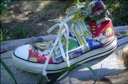Alek Joyce leaves behind a Converse shoe at an Avon, Colo., cache he's tracked down. Geocaching enthusiasts can take a treasure from a cache when they find a site, but it's considered good etiquette to leave something in its place.