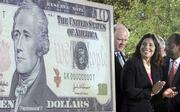 John Snow, left, secretary of the Treasury; Anna Escobedo Cabral, center, treasurer of the United States, and Roger Ferguson Jr., vice chairman for the Board of Governors of the Federal Reserve System, attend a ceremony Wednesday that unveiled the new $10 note.