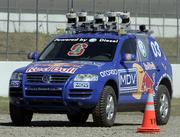 A modified Volkswagen Toureg, built by students and faculty from Stanford University, navigates around a cone on a course at the California Speedway in Fontana, Calif. The robot was among the top finishers during the Defense Advanced Research Projects Agency Grand Challenge on Wednesday.