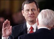 Supreme Court Justice John Paul Stevens swears in John Roberts Thursday as the chief justice of the United States.