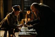 Oliver (barney Clark), left, is schooled by Fagin (Ben Kingsley) while the Artful Dodger (Harry Eden) looks on in Roman Polanski&squot;s new adaptation of Charles Dickens&squot; "Oliver Twist."