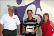 Hank Booth, left, and Becky Price, right, present Craig Miller with a Platinum Family Membership to Lawrence Athletic Club on Sept. 7 for being the second-place winner in the Big Brothers Big Sisters of Douglas County's 2005 Bowl For Kids' Sake event. Booth is the 2006 Bowl for Kids' Sake co-chair, and Price is regional executive director of Kansas Big Brothers Big Sisters.