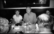 Wearing pilgrimage medals received at a Washington National Cathedral event, Mary and Doug Glasnapp enjoy a dinner with other members of the Motet Singers. Mary sang with the group Aug. 21 when it performed the Choral Prelude for Kansas State Day.