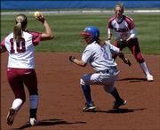Jackie Vasquez, center, gets caught in a run down during a KU softball game against the Oklahoma Sooners on April 24 in Lawrence. Vasquez says she was wrongfully dismissed from the KU softball team after filing a complaint about the conduct of coach Tracy Bunge after an April 2 loss.