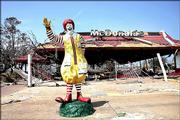 Emergency crews signed their names on the still-standing Ronald McDonald statue outside the demolished restaurant on the coast between Biloxi and Gulfport, Miss.