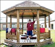 Red Cross volunteer Gary Smith sets up house inside a gazebo outside a Red Cross shelter in Pearl River, La.