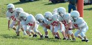 The Cardinals offsense practices running plays before their game against the Gorillas Sunday at Youth Sports Inc. The Gorillas proved to be a tough test for the Cardinals, defeating them 19-0.