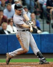 Houston's Morgan Ensberg connects for a run-scoring single against Atlanta. Ensberg drove in five runs, and the Astros defeated the Braves, 10-5, Wednesday in Atlanta.