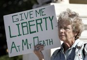 Ruth Gallaid, from Eugene, Ore., who supports physician-assisted suicide, protests in front of the Supreme Court in Washington. The Supreme Court on Wednesday revisited the emotionally charged issue of physician-assisted suicide in a test of the federal government's power to block doctors from helping terminally ill patients end their lives.