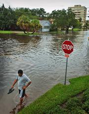 Gregory Aikens wades past a flooded intersection in San Marco, Fla. Heavy rains from Tropical Storm Tammy on Wednesday left several streets impassable in the area. Hurricane experts say that there is still a chance for at least one more powerful storm to hit the U.S. this year. The hurricane season runs through November.