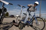 Ken Gates, Overland Park, checks out an electric bike at the Lawrence Home Energy Conservation Fair at the Douglas County 4-H Fairgrounds on Sunday afternoon.