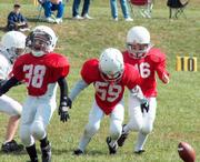 Chops Calton Lovelace, left, Justin Lewis, center, and Hunter Caughbon attempt to recover a fumble Sunday at Youth Sports Inc.