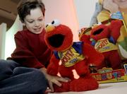 Matthew Conboy, 6, of Elmwood Park, N.J., plays with a Shout Elmo by Mattel. Toy retailers are prepared for a difficult season, and are planning big discounts and other promotions.