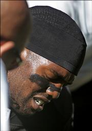 Oakland wide receiver Randy Moss grimaces after injuring his groin during the first quarter against the Chargers. The Raiders fell, 27-14, Sunday in Oakland, Calif.