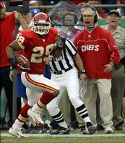 Kansas City strong safety Sammy Knight (29) runs along the sideline past defensive coordinator Gunther Cunningham, right, as he returns a fumble recovery for a touchdown in the third quarter. The Chiefs beat the Redskins, 28-21, Sunday in Kansas City, Mo.