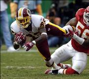 Kansas City linebacker Derrick Johnson (56) reels in Washington receiver Santana Moss (89) after Moss' catch for a first down early in the third quarter. The Chiefs won, 28-21, Sunday in Kansas City, Mo.