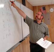 Ron Krestan instructs Veritas Christian School seniors in his Bible/rhetoric class at the Lawrence school, 256 N. Mich. Krestan is certified to teach science courses in public schools in Kansas but he doesn't believe in evolution.
