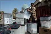 An Iraqi soldier loads ballot boxes in a truck to ship them for counting in Baghdad, Iraq. Election officials on Sunday counted millions of paper ballots from Iraq's constitutional referendum.