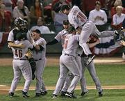 Houston's Luke Scott (30) leaps on top of teammates as they celebrate their victory over St. Louis. The Astros defeated the Cardinals, 5-1, Wednesday night in St. Louis to claim the NL championship series, 4-2.