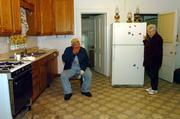 Joe and Shirley Noll take a break while cleaning up their home of 50 years. The house near McLouth was flooded with 2 feet of water on Oct. 2 as heavy rains swamped much of northeast Kansas. The Nolls did not have flood insurance.