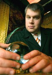 Author Daniel Handler, aka Lemony Snicket, is shown in a card reader booth at Cafe Flore in San Francisco. The 12th installment of his children&squot;s book series, "A Series of Unfortunate Events," came out Tuesday.