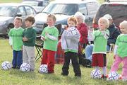 A group of Hobbits line up to get ready to charge their parents in a drill where they try to learn how to use footwork to go downfield for a goal on Saturday at Youth Sports Inc.