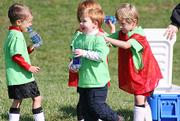 Hobbits Andrew Wallen, left, Walker Koberlein, center, and Christopher Nelson laugh during a water break Saturday at Youth Sports Inc.