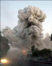 An explosion is seen Monday in downtown Baghdad. The Palestine Hotel, which houses many foreign journalists in Iraq, was hit by two rockets and one car bomb, causing considerable damage to rooms and killing at least six passers-by, Iraqi police said.