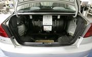 The gas tank is stored in the trunk of Honda's natural-gas powered Civic GX. With gasoline prices up 90 cents a gallon from a year ago, motorists are able to get natural gas fill ups at home. Honda plans to expand sales of the natural gas Civic GX next year to major cities around the country.