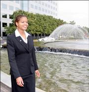 Yemaya Stallworth, an engineer at General Electric Co. in Atlanta and Clark Atlanta University student, walks Oct. 20 in the fountain area of the complex during a break. The black university has decided to eliminate the engineering department in May 2008 as part of a cost-cutting move at financially troubled Clark Atlanta. The department is Georgia's only black engineering program.