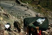 Pakistani earthquake survivors walk down from their mountain villages Thursday near Kawai, Pakistan. Scores of Pakistanis, left homeless by the Oct. 8 earthquake, are migrating to lower land before the harsh winter arrives to cut them off from aid.