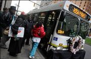 Riders board the Rosa Parks Memorial Bus as it stops Thursday on Woodward Avenue in Detroit. Parks' refusal to give up her bus seat to a white man in Montgomery, Ala., in 1955 led to a 381-day boycott of the city's bus system and helped spark the modern civil rights movement. She died Monday in Detroit at age 92.
