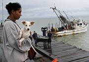 Merry Lopez, 29, evacuee of Cayo Miskitu, arrives Saturday on the wharf of Puerto Cabezas. Nicaragua issued a hurricane warning for its Caribbean coast and evacuated thousands as forecasters predicted the hurricane would strengthen before hitting Central America.