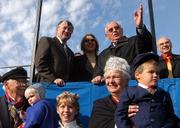 Former Soviet President Mikhail Gorbachev, upper right, waves to parade participants Saturday in downtown Lindsborg. Gorbachev visited the town to attend the Chess for Peace event at nearby Bethany College. The tournament features chess champions Russian Anatoly Karpov, left, and American Susan Polgar, center. The parade participants are unidentified.