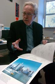 Peter Pran, a Kansas University professor, displays renderings of two towering residential buildings in Singapore that he helped to design.